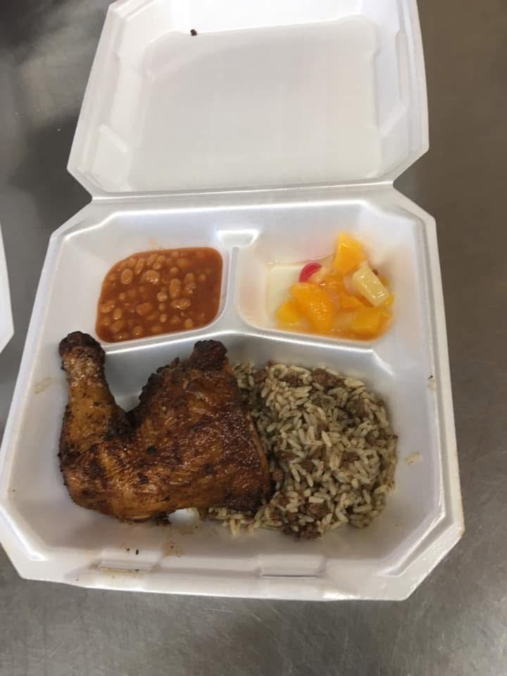 Prepared meal with chicken, rice, beans, and fruit